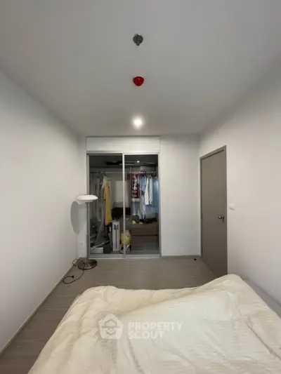 Modern minimalist bedroom with built-in closet and cozy lighting