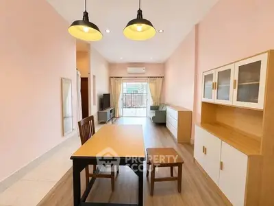 Spacious living room with modern furniture and natural light in a stylish apartment.
