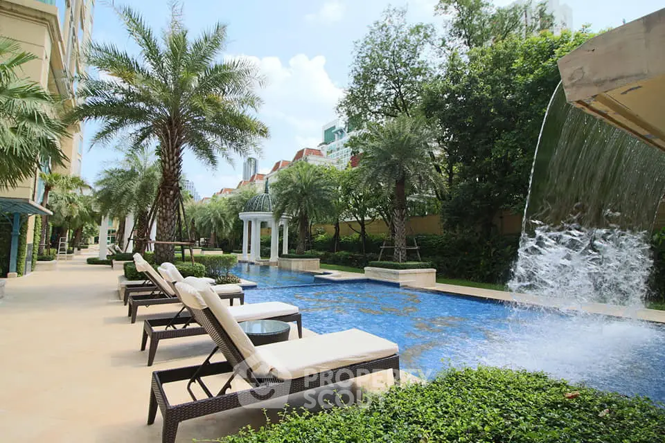 Luxurious poolside oasis with sun loungers and lush greenery in a serene setting.
