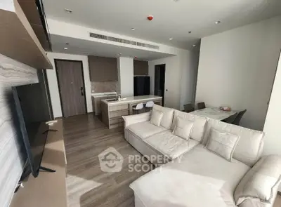 Spacious modern living room with open kitchen and cozy seating area.