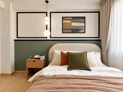 Cozy bedroom with modern decor, featuring a stylish bed, elegant lighting, and a chic wall art piece.