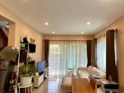 Spacious living room with modern decor and large windows for natural light.