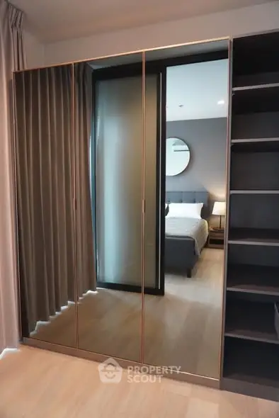 Modern bedroom with mirrored wardrobe and elegant decor