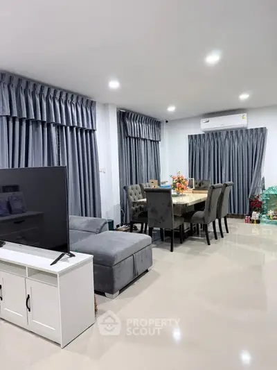 Spacious modern living room with elegant dining area and sleek furniture