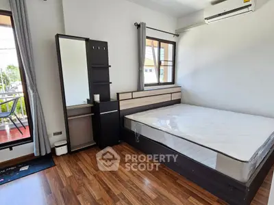Spacious bedroom with modern furniture and balcony view