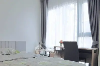 Bright bedroom with modern decor and study desk near large window