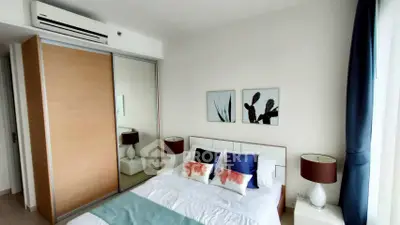 Modern bedroom with stylish decor and large wardrobe in a cozy apartment.