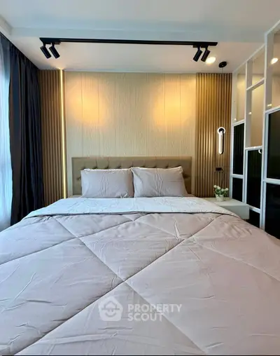 Luxurious bedroom with modern lighting and elegant decor, perfect for relaxation and comfort.