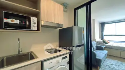 Modern studio apartment with compact kitchen and cozy living area