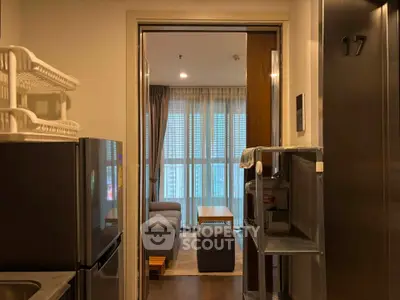 Modern apartment interior with cozy living room and kitchen view, featuring stylish furniture and natural light.