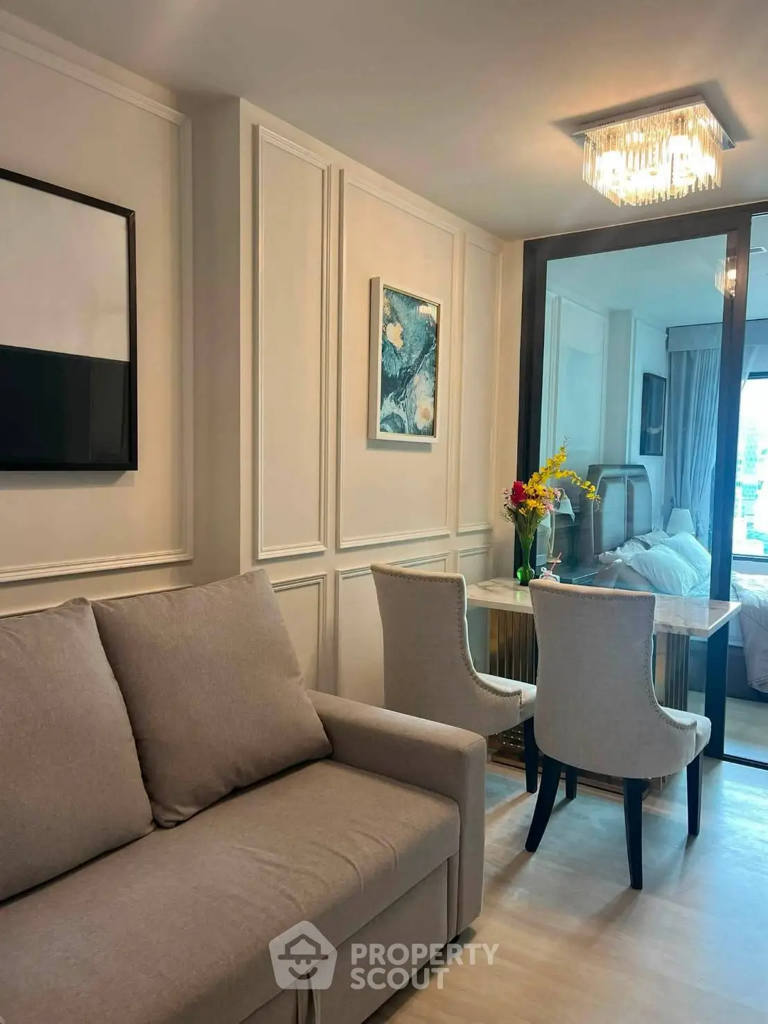 Elegant living room with modern decor and cozy seating in a stylish apartment.