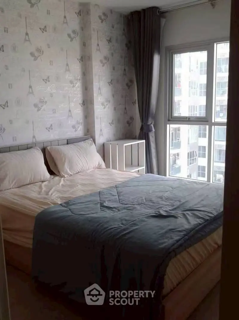 Cozy bedroom with large window and stylish wallpaper in modern apartment