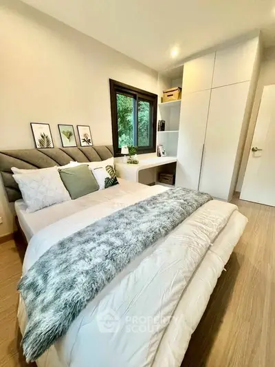 Modern bedroom with stylish decor and large window view