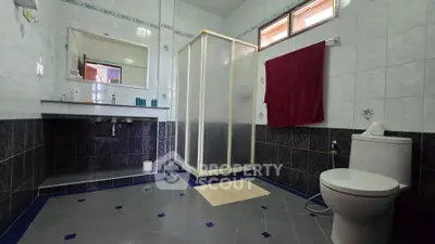 Spacious bathroom with modern shower and elegant tile design