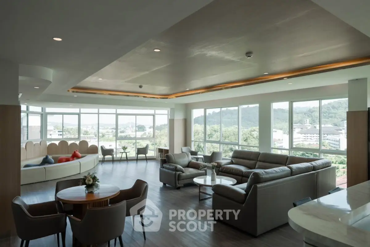 Spacious modern living room with panoramic windows and elegant furnishings