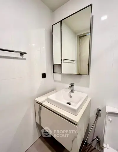Modern bathroom with sleek vanity and mirror in contemporary apartment