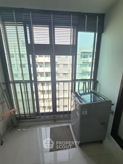 Modern apartment balcony with washing machine and city view