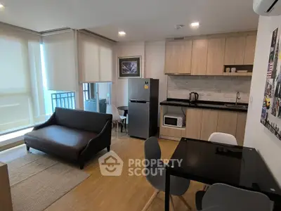 Modern living room with sleek kitchen and dining area in stylish apartment