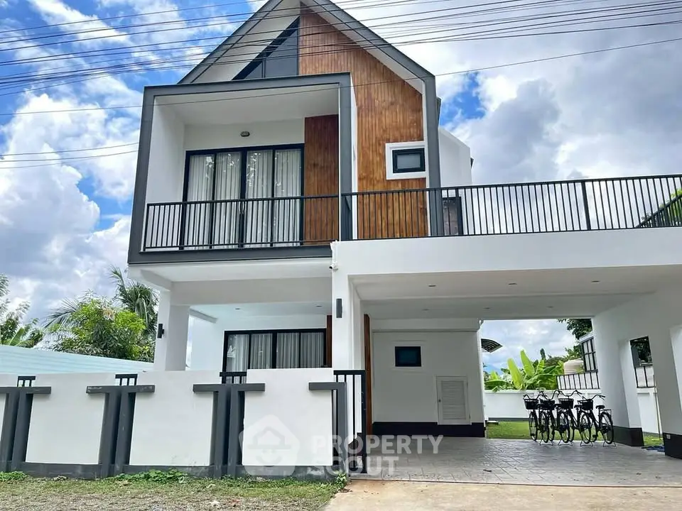 Modern two-story house with wooden accents and spacious carport in a serene neighborhood.