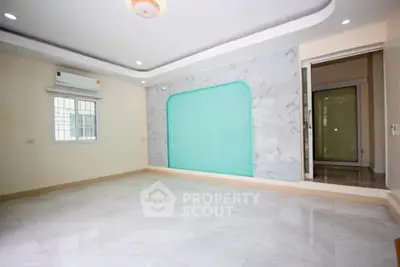 Spacious modern living room with elegant marble accents and air conditioning.