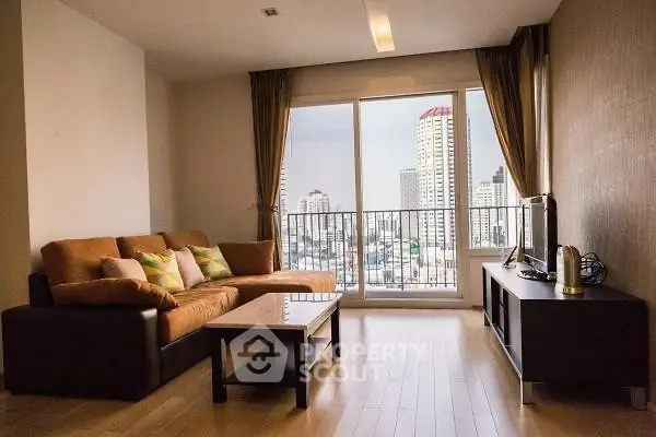 Spacious living room with city view, modern furniture, and large windows for natural light.