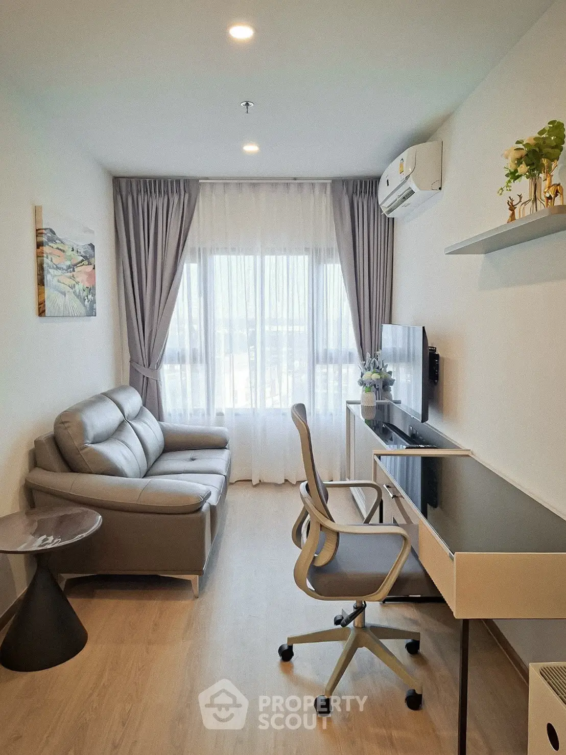 Modern living room with sleek furniture and natural light, perfect for urban living.