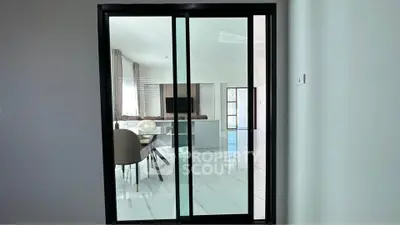 Modern living room with sliding glass doors and elegant dining area