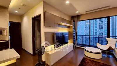 Modern living room with large windows and stylish furniture in a high-rise apartment.