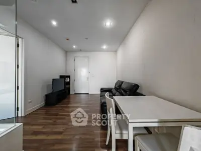 Modern living room with sleek furniture and wooden flooring, perfect for cozy gatherings.
