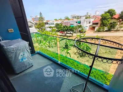 Charming balcony with lush greenery and city views, perfect for relaxation and enjoying the outdoors.