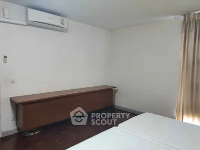 Spacious bedroom with air conditioning and natural light