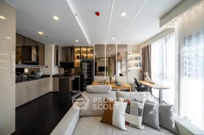 Modern open-layout living room with stylish kitchen and natural light