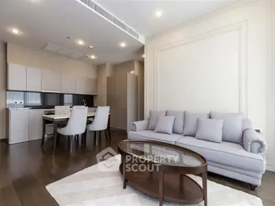 Modern living room with elegant furniture and open kitchen layout in a stylish apartment.