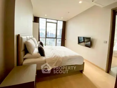 Modern bedroom with city view, featuring sleek design and natural light.