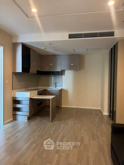 Modern kitchen with sleek cabinetry and open layout in a stylish apartment.