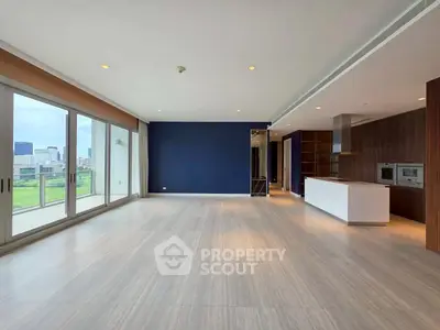 Spacious modern living room with open kitchen and city view