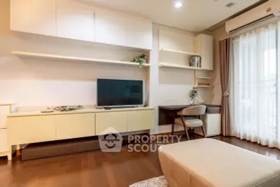 Modern living room with stylish furniture and large window for natural light.