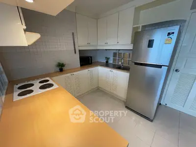 Modern kitchen with sleek appliances and ample storage space