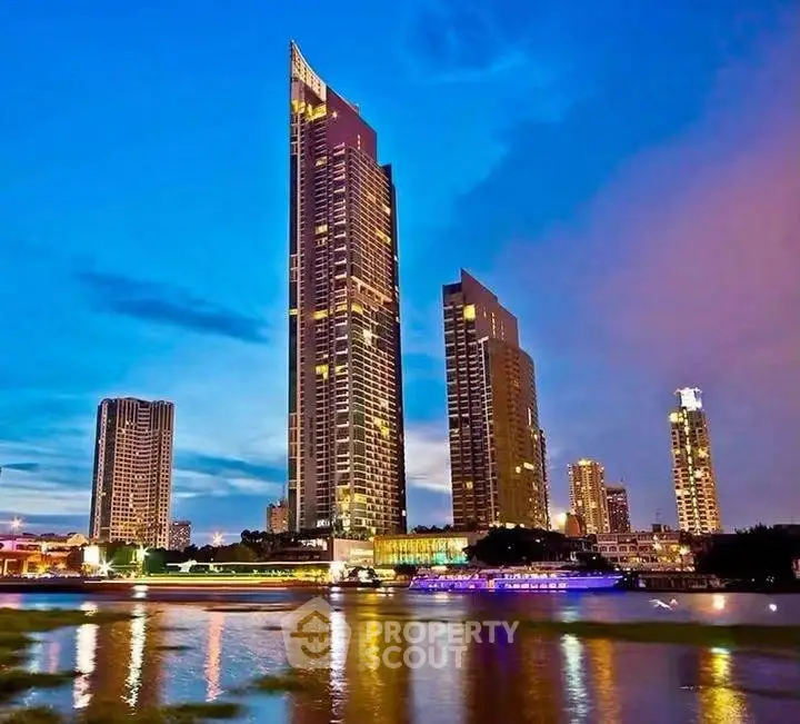 Stunning skyline view of modern high-rise buildings by the river at dusk, showcasing urban luxury living.