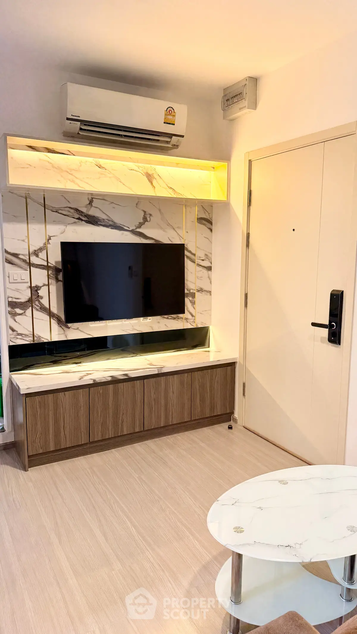 Modern living room with marble accents and sleek air conditioning unit