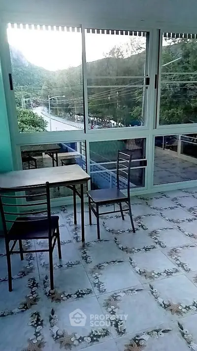 Spacious balcony with scenic view and tiled flooring, perfect for relaxation.