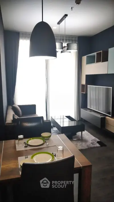 Modern living room with stylish decor and dining area in a contemporary apartment.