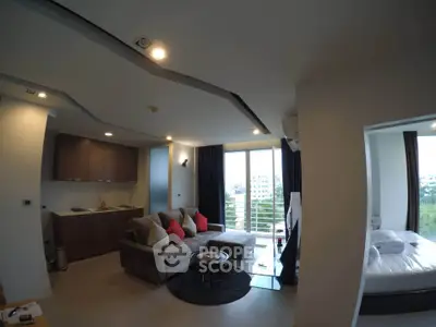 Modern open-layout living room with kitchen and balcony view in a stylish apartment.