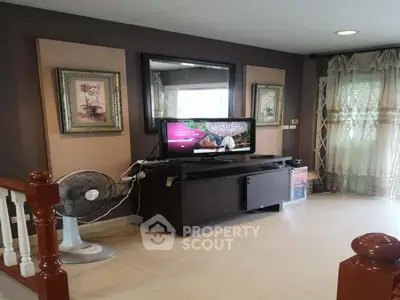 Cozy living room with TV and elegant decor in modern home