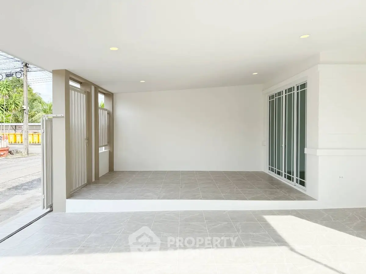 Spacious modern garage with tiled flooring and sliding glass doors
