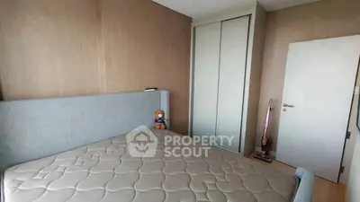 Cozy bedroom with modern design, featuring a plush bed and built-in wardrobe.