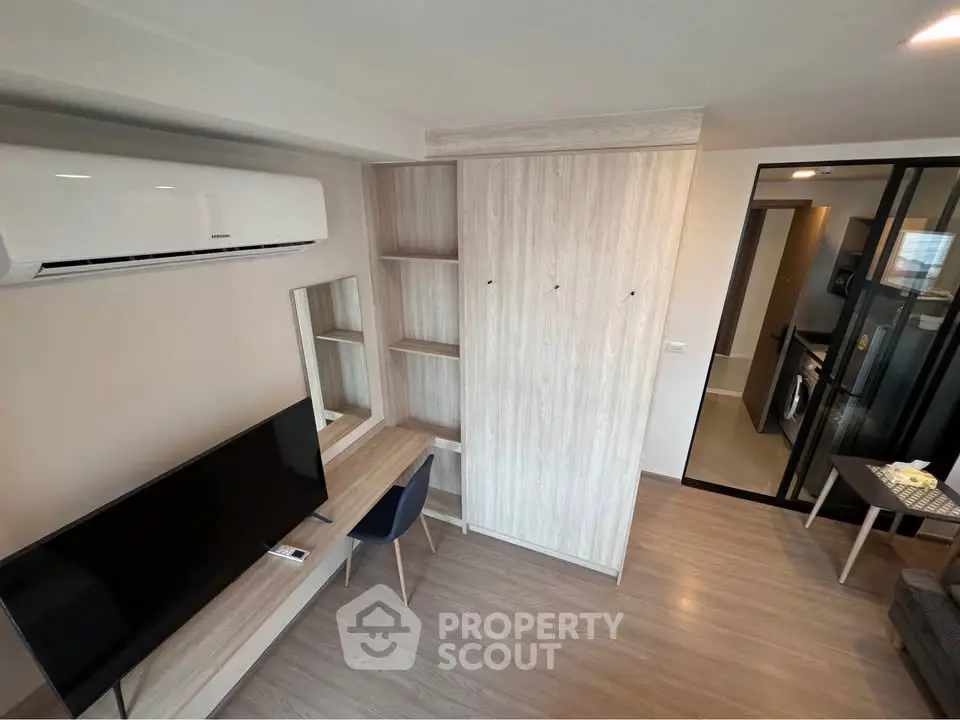 Modern living room with sleek furniture and built-in storage in a stylish apartment.