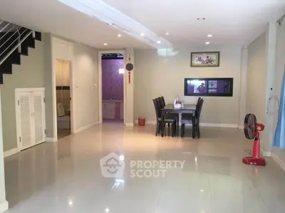 Spacious open-plan living and dining area with modern decor and ample natural light.