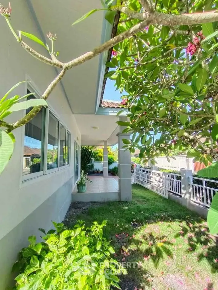 Charming suburban home with lush garden and spacious patio, perfect for outdoor relaxation.