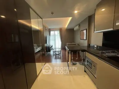 Modern open-layout kitchen with sleek appliances and stylish living area